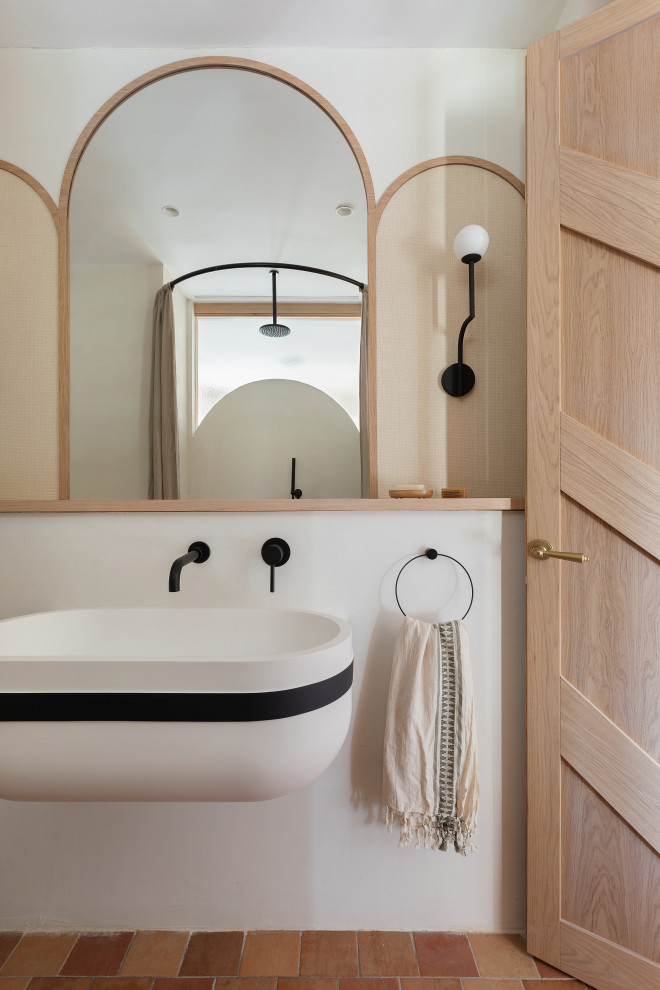 This is an example of a contemporary bathroom in Other with white walls, terracotta flooring, a wall-mounted sink, red floors and a single sink.