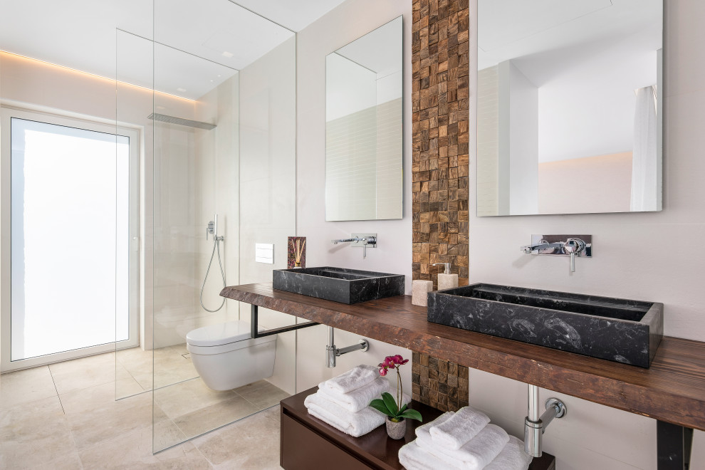 This is an example of a large contemporary ensuite bathroom in Alicante-Costa Blanca with medium wood cabinets, a walk-in shower, white walls, a vessel sink, wooden worktops, beige floors, an open shower, brown worktops, double sinks, a floating vanity unit and flat-panel cabinets.