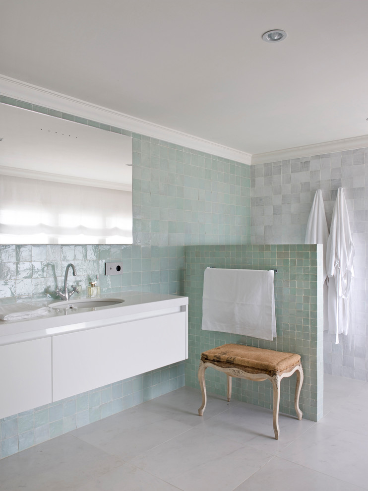 Ejemplo de cuarto de baño principal mediterráneo con puertas de armario blancas, baldosas y/o azulejos verdes, baldosas y/o azulejos grises, ducha abierta, encimeras blancas, armarios con paneles lisos, paredes multicolor, lavabo bajoencimera y suelo gris