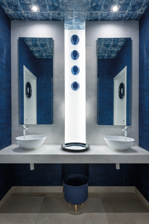 Marble Marvel: Blue Bathroom Design with a Marble Vanity and Vessel Sinks