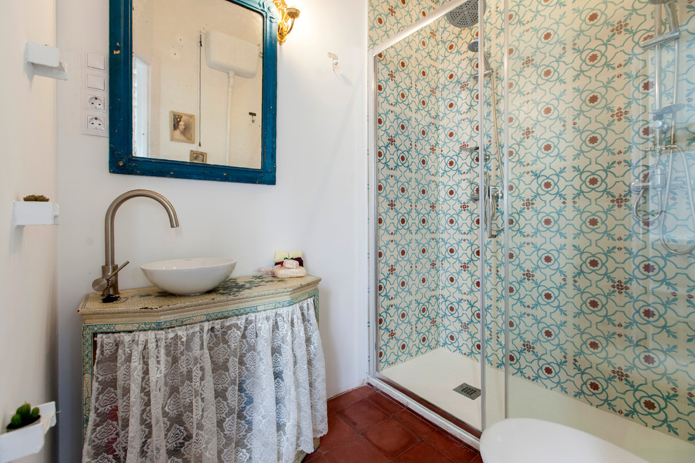 Mid-sized eclectic master terra-cotta tile alcove shower photo in Madrid with open cabinets, a two-piece toilet, multicolored walls and a vessel sink