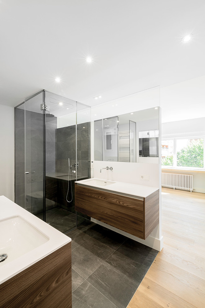 Inspiration for a large scandinavian ensuite bathroom in Madrid with freestanding cabinets, dark wood cabinets, a built-in shower, a wall mounted toilet, black tiles, slate tiles, white walls, slate flooring, a submerged sink, marble worktops, black floors and a hinged door.