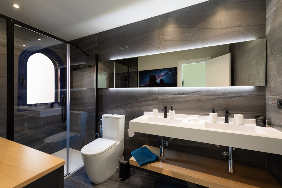 Imagen de cuarto de baño contemporáneo con ducha empotrada, baldosas y/o azulejos grises, lavabo integrado, suelo gris y encimeras blancas