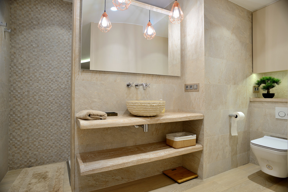 Idée de décoration pour une douche en alcôve design avec un placard sans porte, WC suspendus, un carrelage beige, un mur beige, une vasque, un plan de toilette en bois, un sol beige, aucune cabine et un plan de toilette beige.