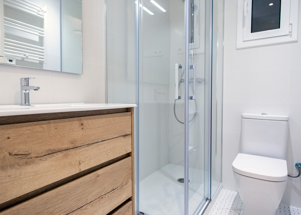 На фото: главная ванная комната среднего размера в современном стиле с угловым душем, унитазом-моноблоком, белой плиткой, белым полом, душем с раздвижными дверями и белой столешницей с