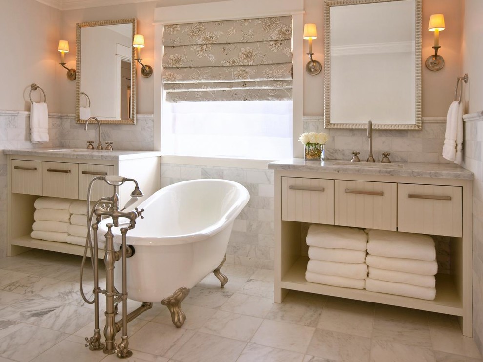 Diseño de cuarto de baño principal tradicional de tamaño medio con armarios abiertos, paredes multicolor, lavabo integrado, puertas de armario beige y bañera con patas