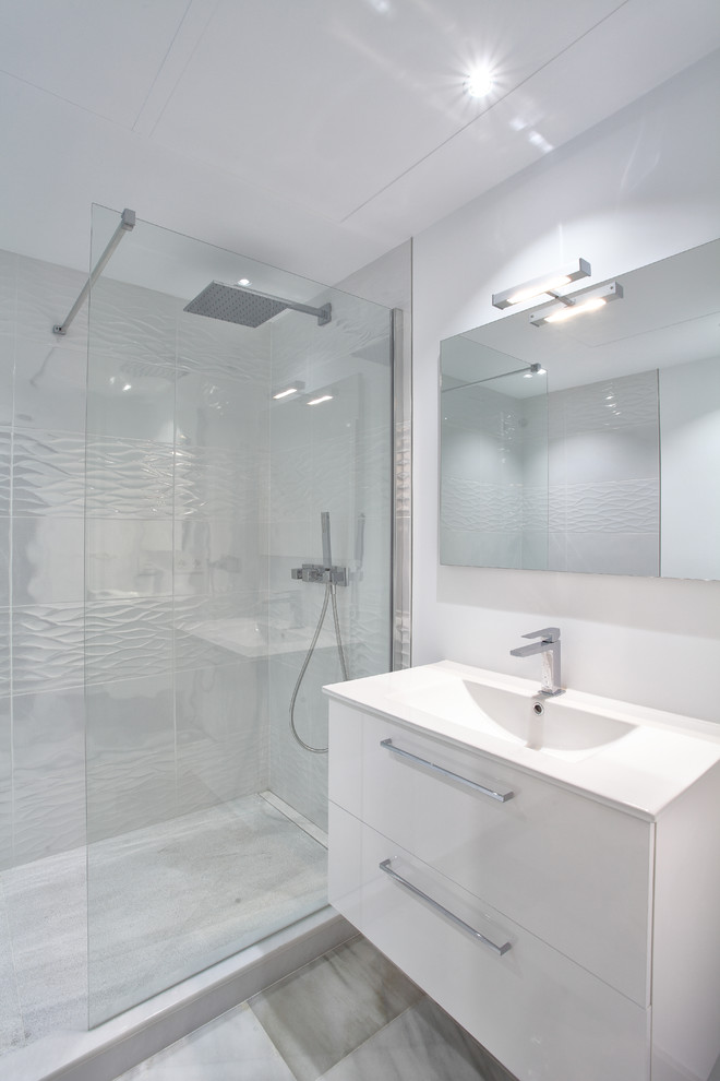 Bild på ett mellanstort funkis badrum med dusch, med släta luckor, vita skåp, en dusch i en alkov, vita väggar och ett integrerad handfat