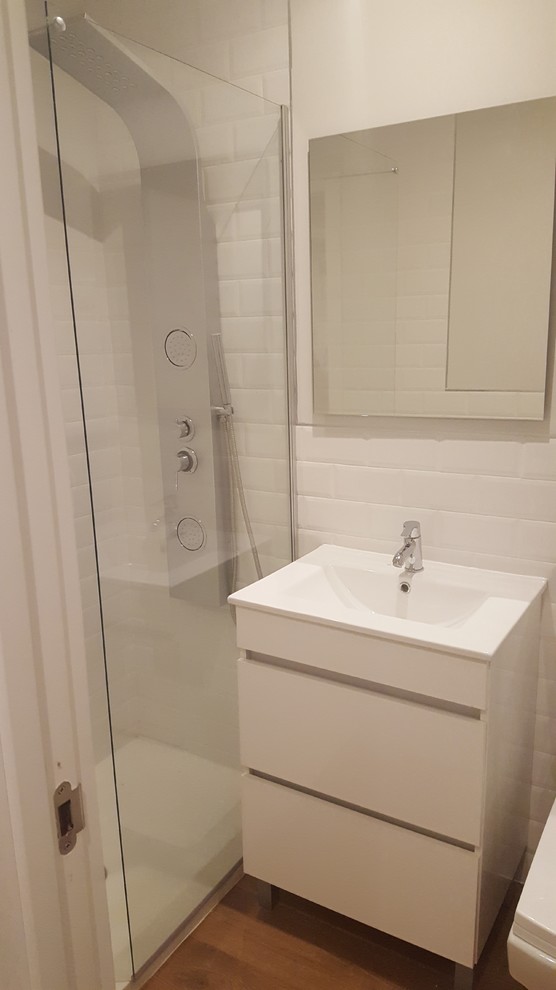 Idee per una piccola stanza da bagno con doccia scandinava con ante lisce, ante bianche, doccia alcova, pareti bianche, pavimento in legno massello medio e lavabo integrato