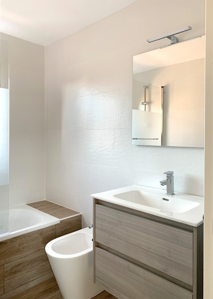 Transitional master white tile and ceramic tile ceramic tile drop-in bathtub photo in Madrid with medium tone wood cabinets, a wall-mount sink and a floating vanity