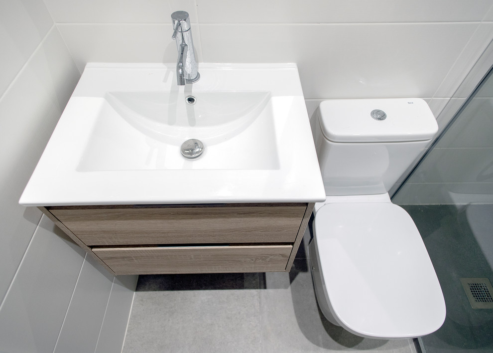 Стильный дизайн: главная ванная комната среднего размера в современном стиле с душем без бортиков, унитазом-моноблоком, белой плиткой, серым полом, душем с раздвижными дверями и белой столешницей - последний тренд