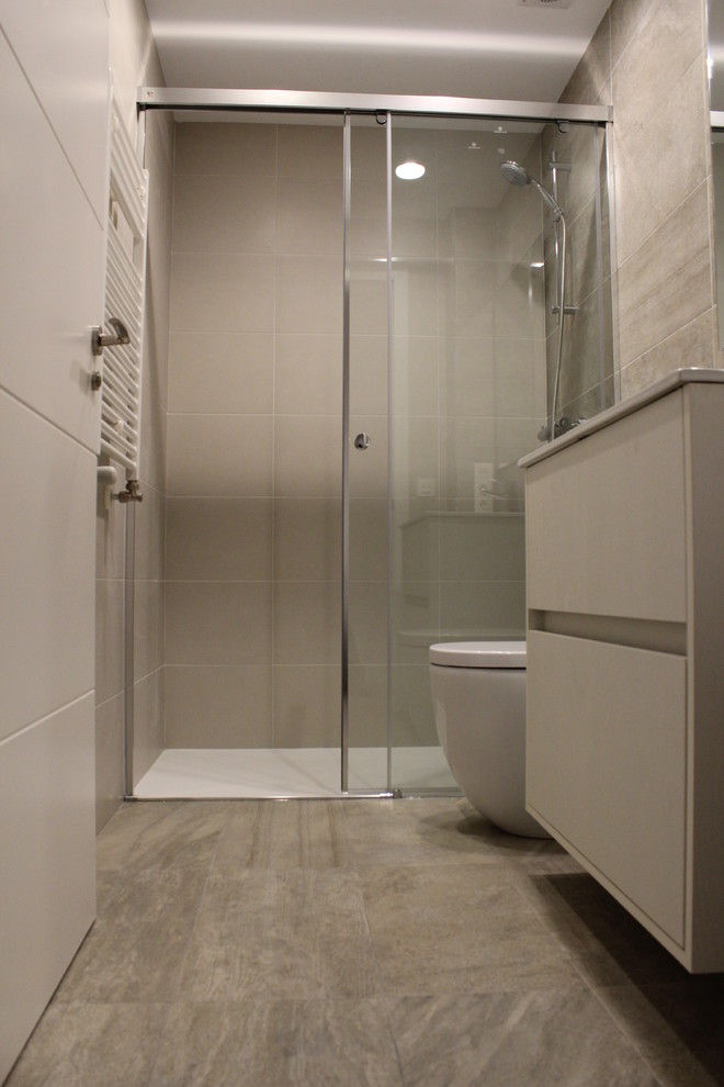 Immagine di una piccola stanza da bagno con doccia chic con ante lisce, ante bianche, doccia alcova, WC sospeso, pareti beige e lavabo integrato