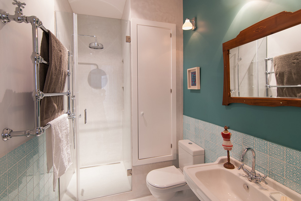 Ispirazione per una stanza da bagno con doccia con doccia ad angolo, WC a due pezzi, lavabo sospeso e pareti blu