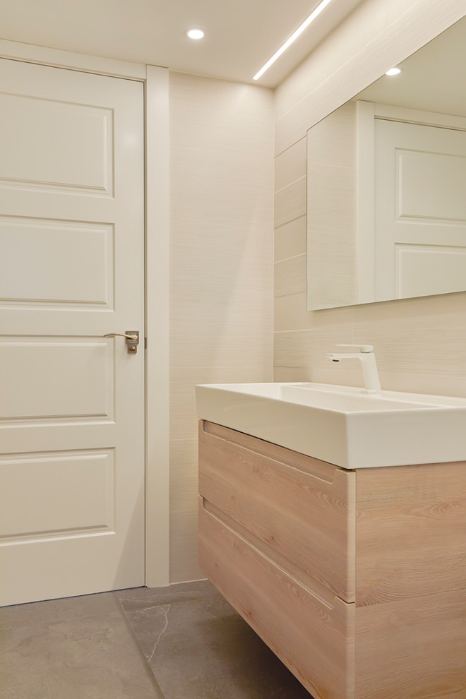 Example of a small minimalist 3/4 beige tile and ceramic tile porcelain tile, gray floor, single-sink and vaulted ceiling bathroom design in Other with open cabinets, white cabinets, an urinal, beige walls, a console sink, quartzite countertops, white countertops and a floating vanity