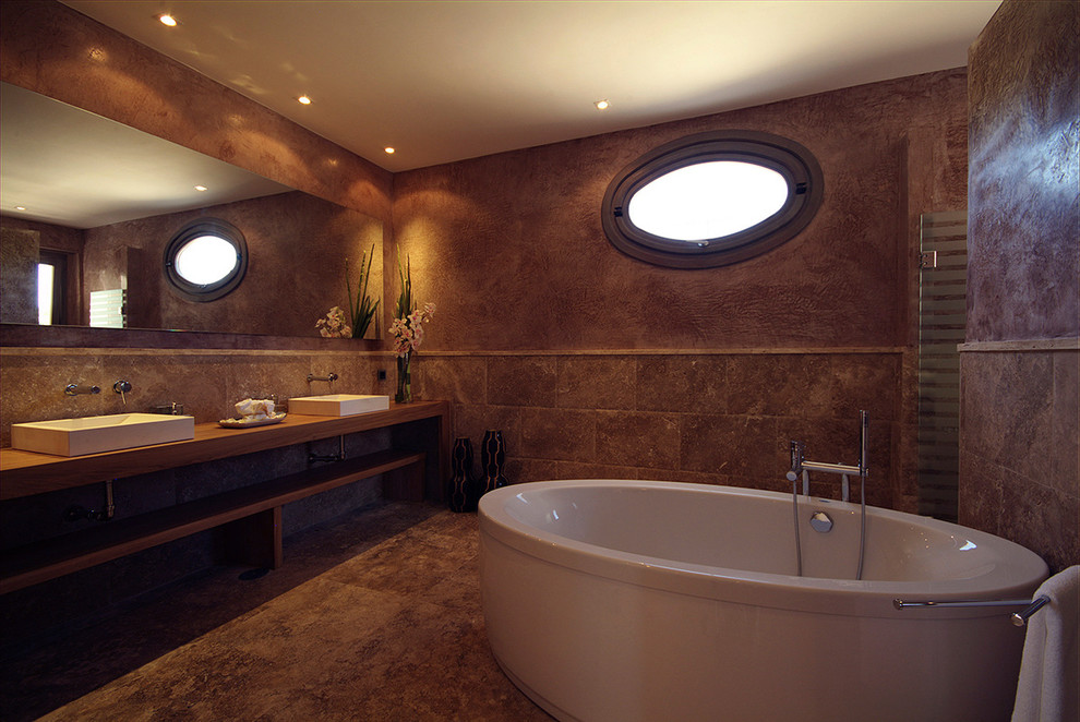 Modelo de cuarto de baño tradicional renovado con baldosas y/o azulejos marrones, baldosas y/o azulejos de travertino, paredes marrones, suelo de travertino y suelo marrón