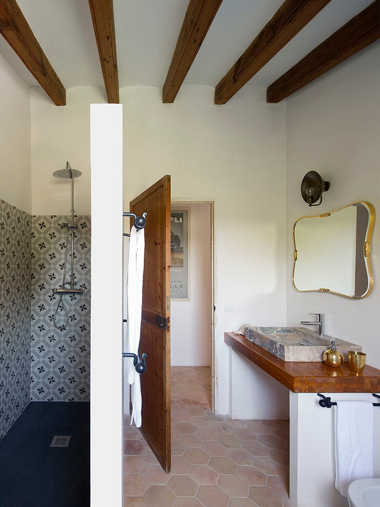 Inspiration for a mid-sized cottage 3/4 bathroom remodel in Barcelona with white walls, a trough sink and wood countertops