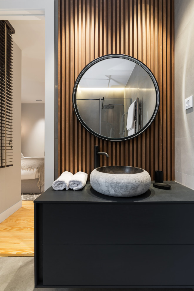 Mittelgroßes Modernes Duschbad mit flächenbündigen Schrankfronten, schwarzen Schränken, grauer Wandfarbe, Aufsatzwaschbecken, grauem Boden, schwarzer Waschtischplatte, Einzelwaschbecken und schwebendem Waschtisch in Madrid