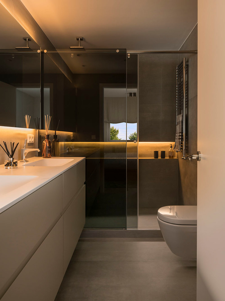 Inspiration for a medium sized contemporary ensuite wet room bathroom in Other with freestanding cabinets, beige cabinets, a one-piece toilet, beige walls, ceramic flooring, a trough sink and a sliding door.