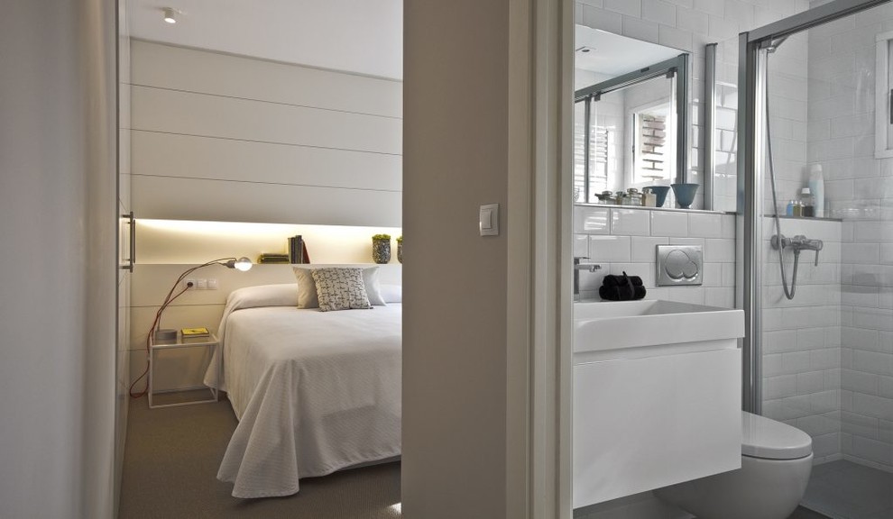 Exemple d'une salle de bain scandinave de taille moyenne avec un placard à porte plane, des portes de placard blanches, WC à poser, un mur blanc et un lavabo intégré.