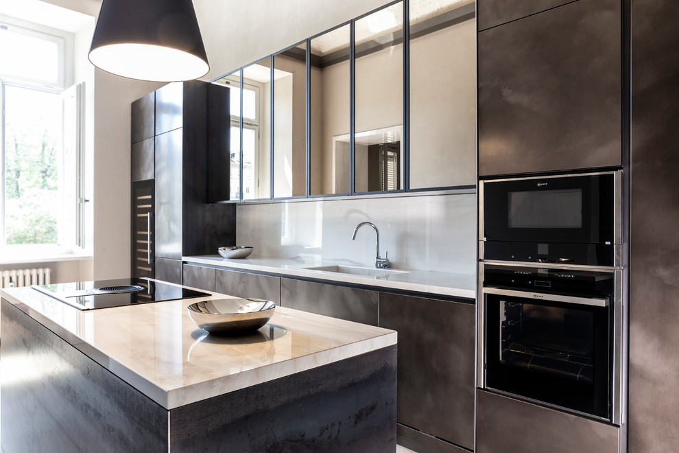 Design ideas for a contemporary galley kitchen in Other with an integrated sink, brown cabinets, beige splashback, black appliances, an island and beige worktops.
