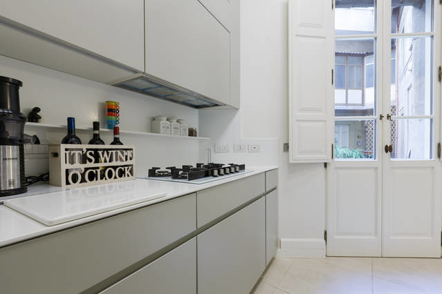 Imagen de cocina lineal contemporánea abierta sin isla con armarios con paneles lisos y puertas de armario grises