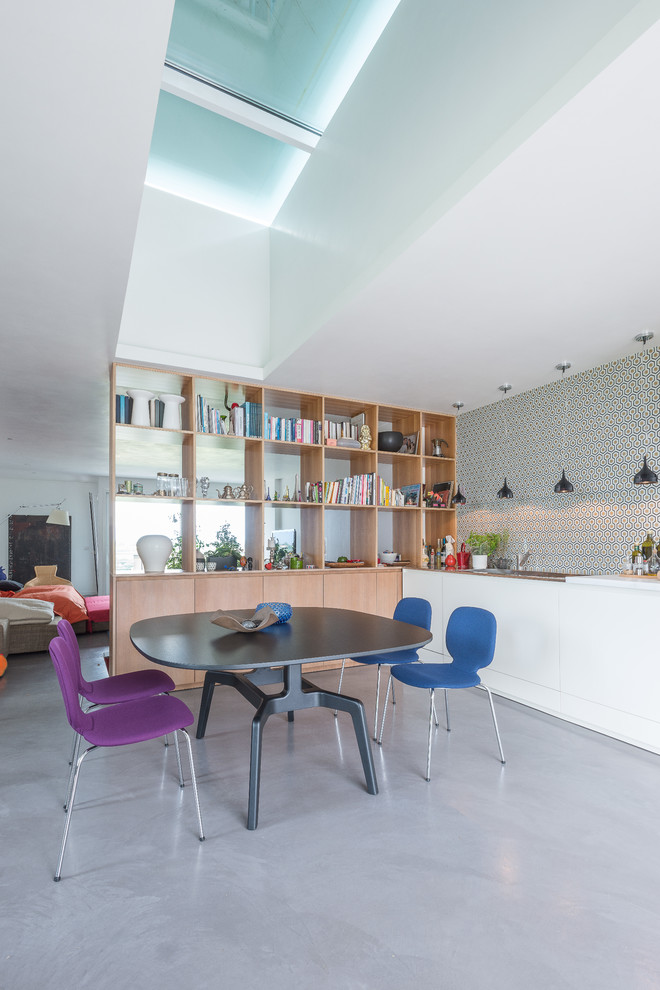 Photo of a large contemporary single-wall open plan kitchen in Other with flat-panel cabinets, white cabinets and ceramic splashback.