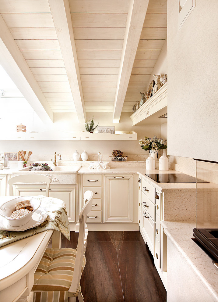 Foto på ett vintage beige kök och matrum, med en rustik diskho, luckor med upphöjd panel, beige skåp, beige stänkskydd och brunt golv