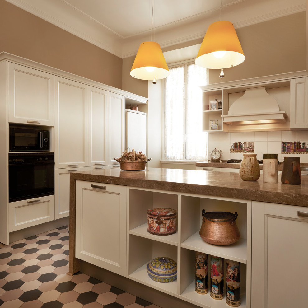 Inspiration for a large 1950s u-shaped ceramic tile and multicolored floor eat-in kitchen remodel in Rome with raised-panel cabinets, white cabinets, marble countertops, white backsplash, ceramic backsplash, black appliances and a peninsula