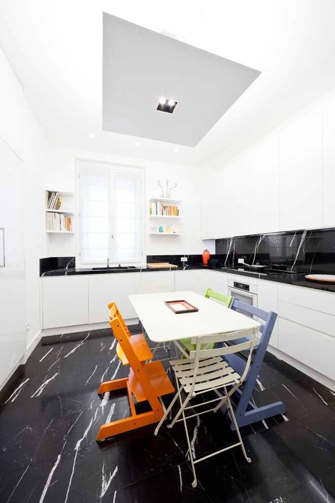 Kitchen - large contemporary marble floor kitchen idea in Milan with an integrated sink, flat-panel cabinets, white cabinets, marble countertops, black backsplash, stone slab backsplash and white appliances