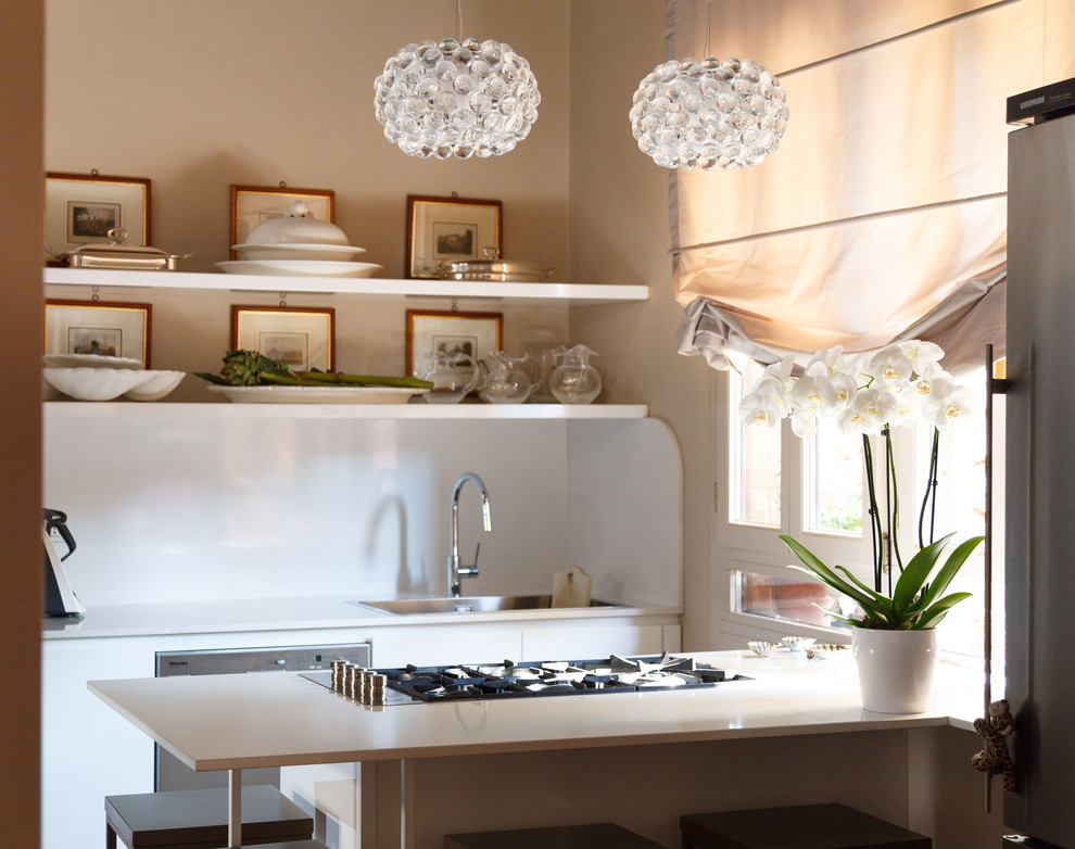 Mid-sized minimalist single-wall terrazzo floor eat-in kitchen photo in Venice with a double-bowl sink, flat-panel cabinets, white cabinets, quartz countertops, stainless steel appliances and an island