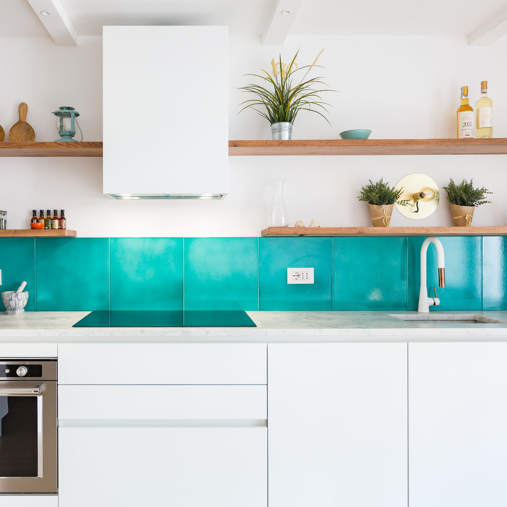 Beach style kitchen photo in Rome with an undermount sink, flat-panel cabinets, white cabinets, marble countertops and blue backsplash