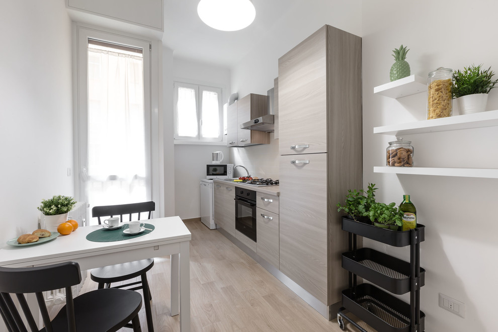 Medium sized contemporary single-wall kitchen in Milan with a built-in sink, flat-panel cabinets, light wood cabinets, laminate countertops, beige splashback, porcelain splashback, integrated appliances, no island, brown floors and light hardwood flooring.
