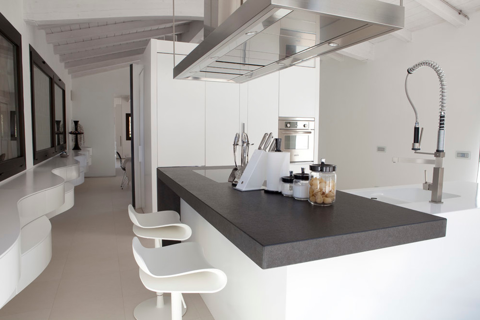 Large contemporary kitchen in Florence with an integrated sink, flat-panel cabinets, white cabinets and an island.