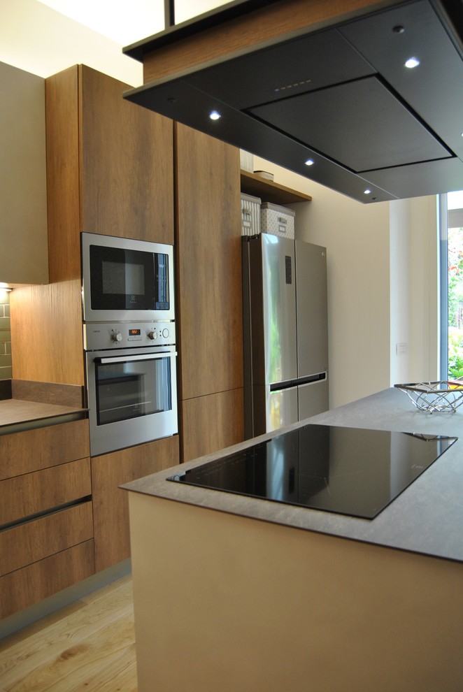 Exempel på ett mellanstort modernt grå grått kök, med en integrerad diskho, släta luckor, skåp i mellenmörkt trä, bänkskiva i koppar, stänkskydd i stickkakel, rostfria vitvaror, ljust trägolv, en köksö och brunt golv