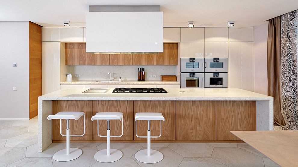 Photo of a large contemporary kitchen in Other with an island, a built-in sink, flat-panel cabinets, light wood cabinets and white appliances.