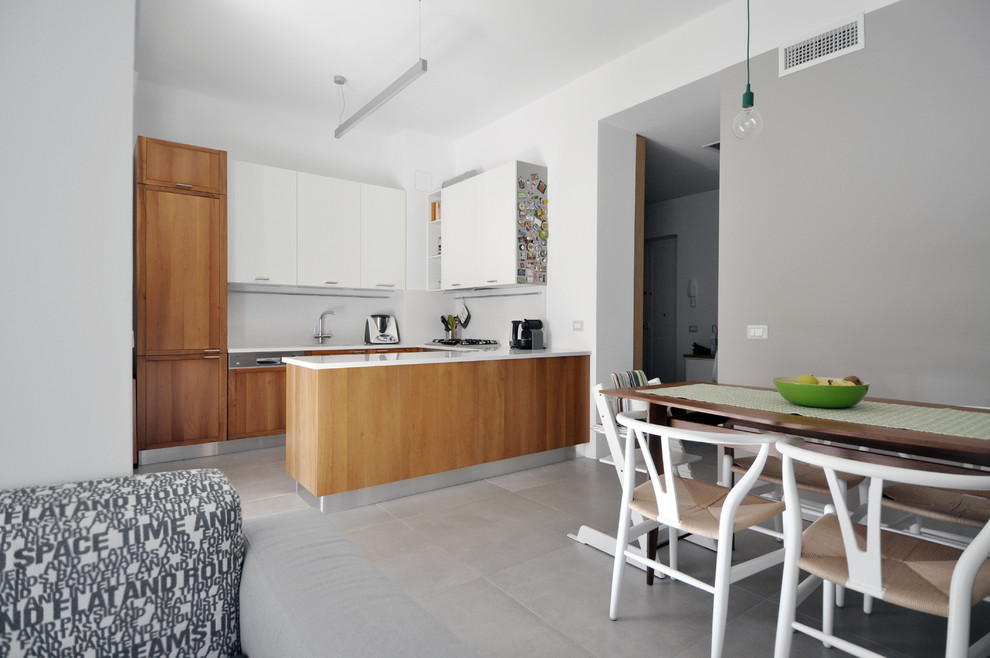 This is an example of a small scandi u-shaped kitchen/diner in Other with a built-in sink, recessed-panel cabinets, medium wood cabinets, engineered stone countertops, beige splashback, marble splashback, stainless steel appliances, ceramic flooring, grey floors and beige worktops.