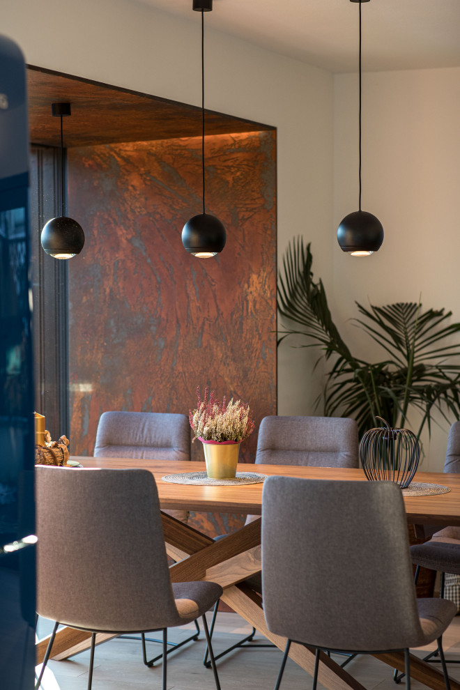 Immagine di una grande sala da pranzo aperta verso la cucina minimalista con pavimento in legno verniciato e pavimento marrone