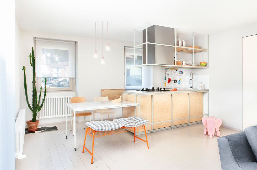 Photo of a contemporary l-shaped open plan kitchen in Milan with light wood cabinets, a submerged sink, open cabinets, white splashback, painted wood flooring, a breakfast bar and white floors.