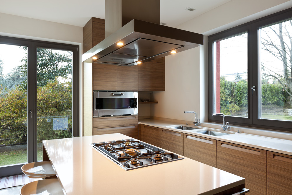 Exempel på ett mellanstort modernt linjärt kök med öppen planlösning, med en undermonterad diskho, släta luckor, skåp i mellenmörkt trä, vitt stänkskydd och en köksö