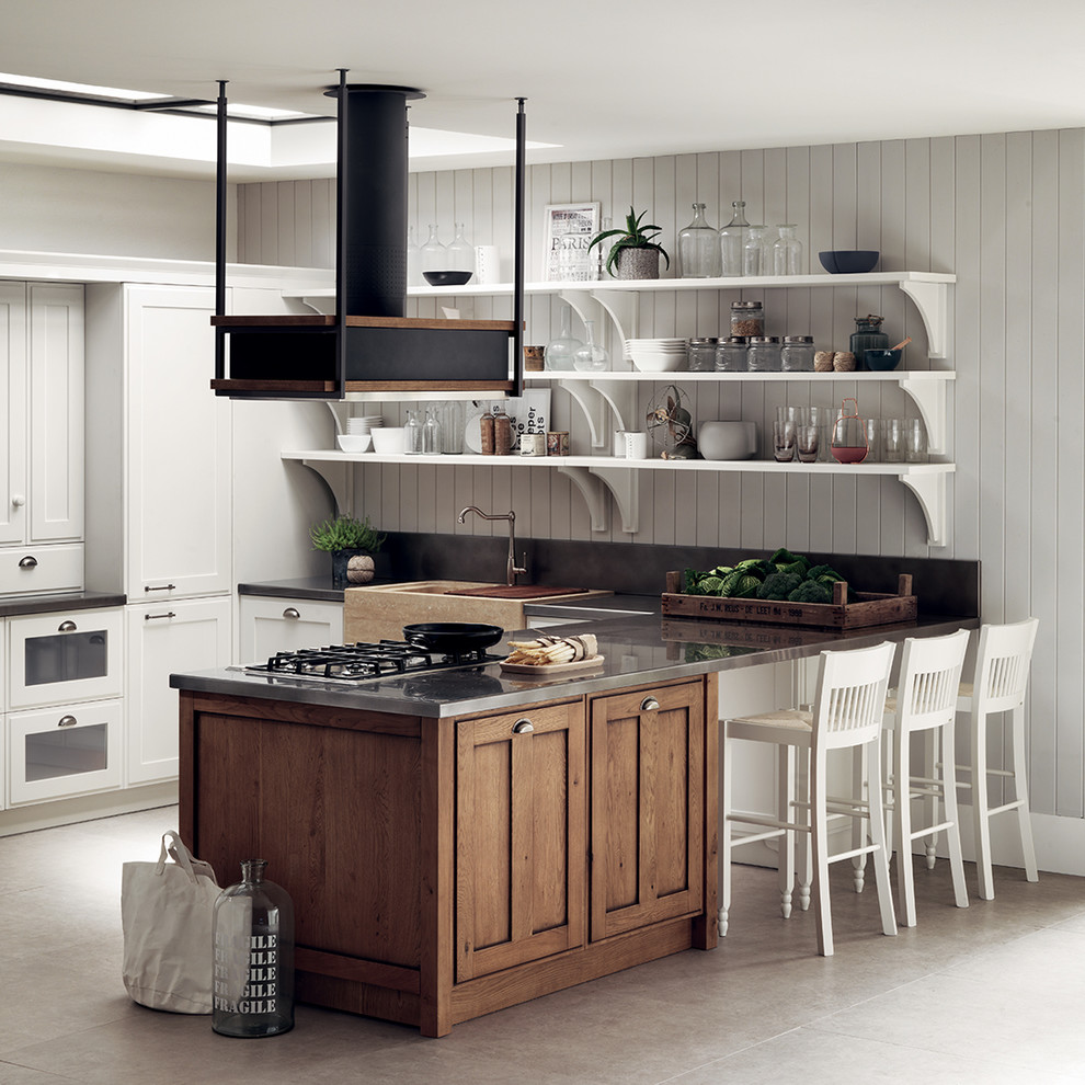 Inspiration for a medium sized romantic single-wall open plan kitchen in Other with a single-bowl sink, recessed-panel cabinets, white cabinets, stainless steel worktops, a breakfast bar and grey worktops.