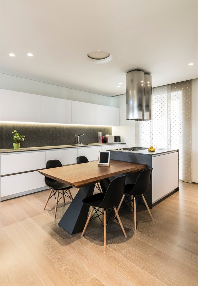 Example of a mid-sized minimalist single-wall painted wood floor open concept kitchen design in Bari with an integrated sink, open cabinets, white cabinets, quartz countertops, stainless steel appliances and an island