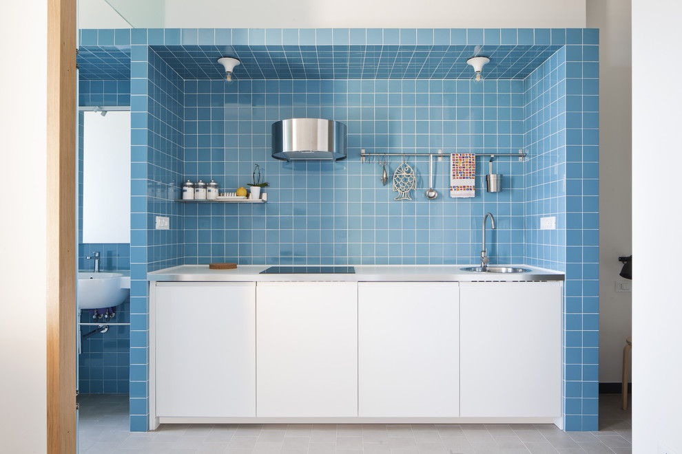 Kitchen - small coastal single-wall white floor kitchen idea in Other with flat-panel cabinets, white cabinets, blue backsplash, ceramic backsplash, paneled appliances, no island and a single-bowl sink