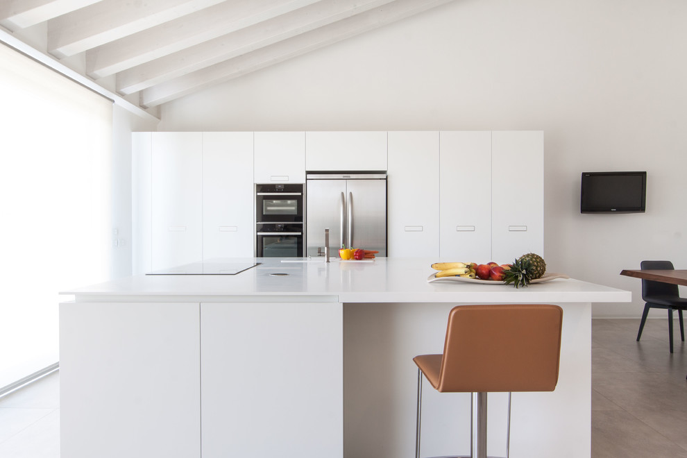 Immagine di una cucina moderna di medie dimensioni con ante lisce, ante bianche, top in quarzo composito e elettrodomestici in acciaio inossidabile
