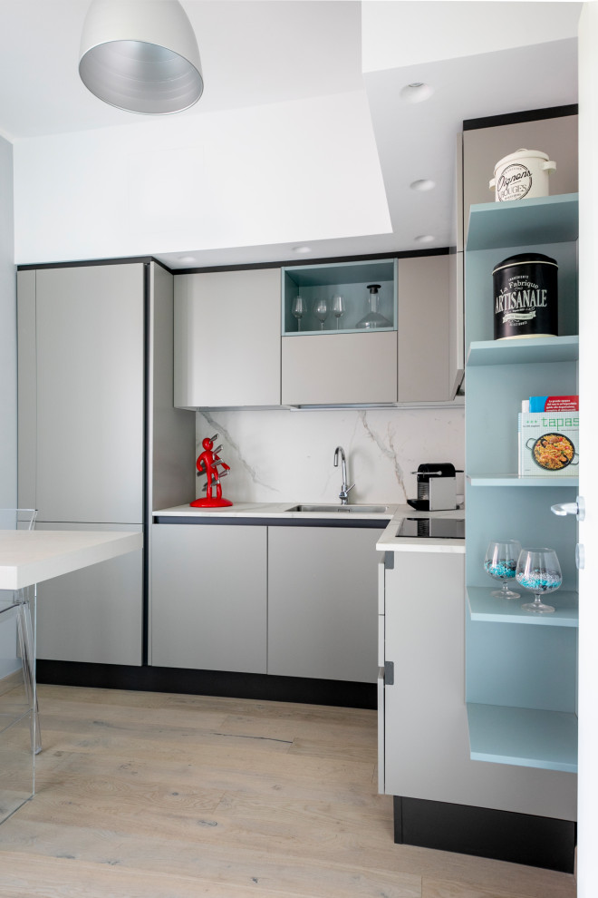 Inspiration for a medium sized contemporary l-shaped enclosed kitchen in Milan with a submerged sink, flat-panel cabinets, grey cabinets, white splashback, porcelain splashback, stainless steel appliances, painted wood flooring and white worktops.