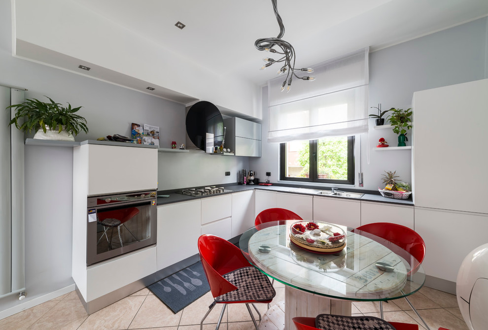 Inspiration for a small contemporary l-shaped ceramic tile open concept kitchen remodel in Milan with an integrated sink, flat-panel cabinets, light wood cabinets, quartz countertops, gray backsplash and stainless steel appliances