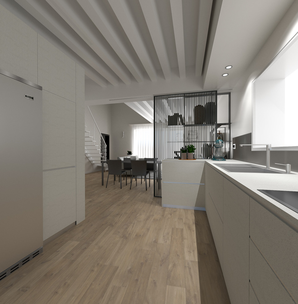Idee per una cucina parallela contemporanea di medie dimensioni con ante lisce, paraspruzzi grigio, elettrodomestici in acciaio inossidabile e top bianco