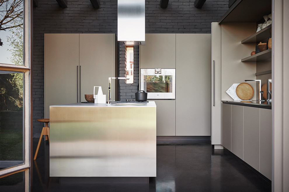 Minimalist l-shaped porcelain tile kitchen photo in Venice with flat-panel cabinets, stainless steel appliances, an island and beige cabinets