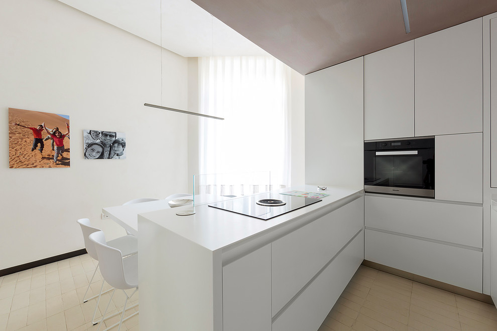 Design ideas for a medium sized contemporary u-shaped enclosed kitchen in Naples with flat-panel cabinets, white cabinets, composite countertops, white splashback, black appliances, an island and white worktops.
