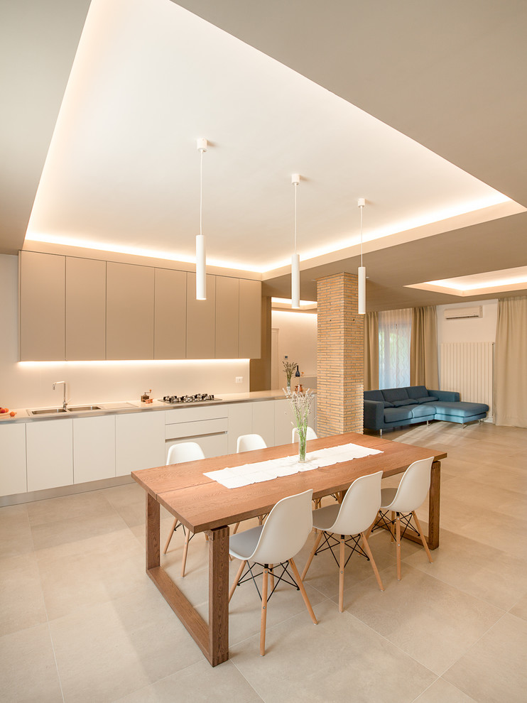 Contemporary single-wall kitchen/diner in Other with flat-panel cabinets, white cabinets, no island, a double-bowl sink and beige floors.