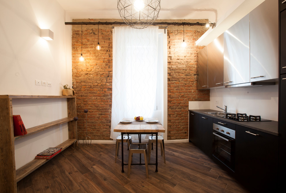 Medium sized urban single-wall kitchen/diner in Milan with porcelain flooring, brown floors, flat-panel cabinets, black cabinets, white splashback, no island, black worktops and a built-in sink.