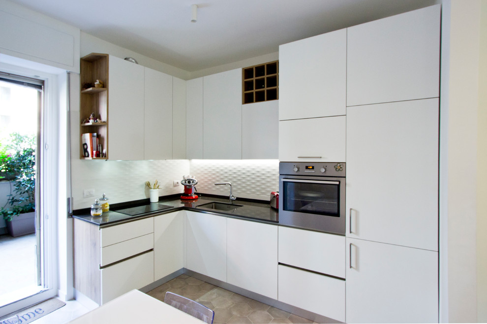 Inspiration for a large contemporary l-shaped enclosed kitchen in Milan with a submerged sink, white cabinets, white splashback, porcelain splashback, stainless steel appliances, porcelain flooring, no island, beige floors, beaded cabinets, quartz worktops and black worktops.